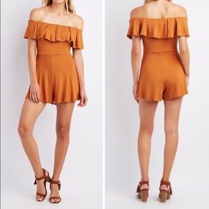 Orange ruffled off shoulder romper.